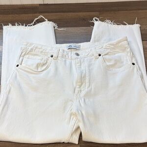 Zara jeans feature a straight-leg cut with a distressed, raw frayed hem